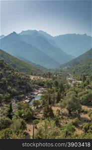 Fango valley in northern Corsica near to Galeria with the river in the foreground and overlapping mountains receding into the distance