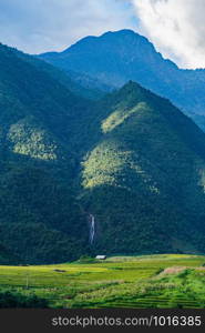 Fansipan mountain hills valley on summer with paddy rice terraces, green agricultural fields in countryside or rural area in travel trip and holidays vacation concept, Sapa, Vietnam. Nature landscape.