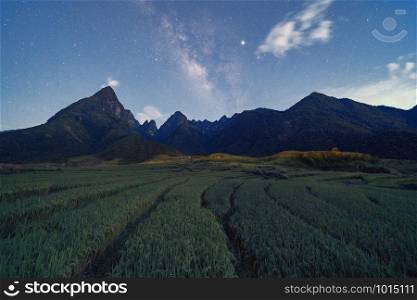 Fansipan mountain hills valley on summer with stars, milky way and paddy rice, agricultural fields at night, Sapa, Vietnam. Nature landscape background.
