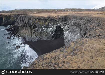 Fantastic Iceland black sand beach with basalt column rocks.