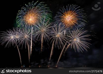 Fantastic Multicolor Firework exploding for Celebration from the big boat over the sea, celebration and happy new year and merry christmas concept