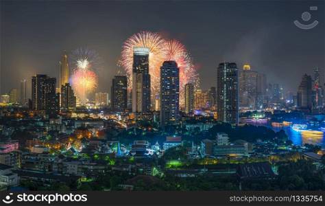 Fantastic Multicolor Firework exploding over the panorama of Bangkok Cityscape river side for Celebration, Business architecture and celebration and happy new year and merry christmas concept
