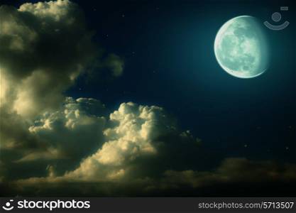 Fantastic night landscape with the big moon, clouds and stars