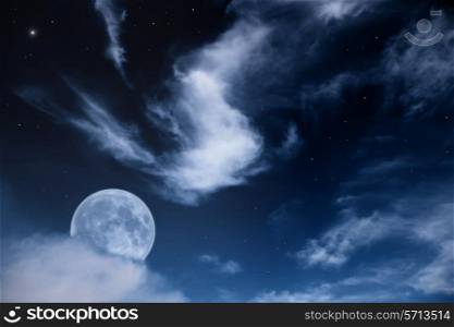 Fantastic night landscape with the moon, clouds and stars