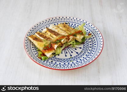 Fantastic plate of Mexican golden tacos ready to give you a good bite on light wooden table