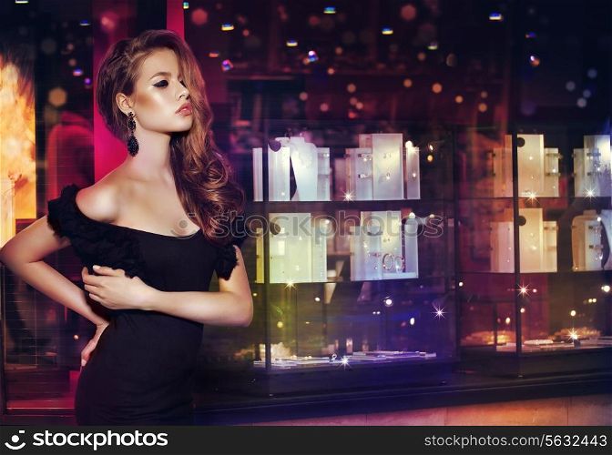Fantasy. Beautiful Lady over Shop Window with Jewels