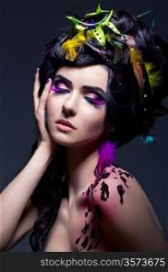 Fantasy. Fashion Female with Colorful Feathers - Bright Makeup