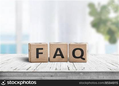 FAQ answers and questions sign made of wooden blocks. Standing on a table in a bright living area.