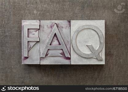 FAQ (frequently asked questions) acronym - text in vintage letterpress metal type against a grunge steel sheet