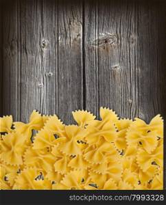 farfalle pasta macro dry on a wooden old table.