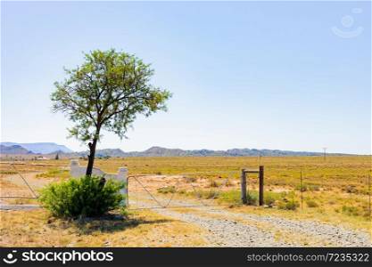 Farm gate and fence in rural grassland area of South Africa