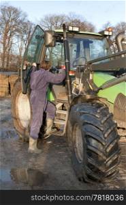 Farm hand boarding a big tractor
