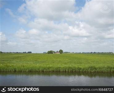 farm in green grassy countryside near european cultural capital 2018 Leeuwarden in Friesland