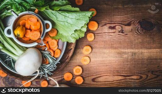 Farm organic Root vegetables for healthy clean vegetarian eating and cooking on rustic wooden background , top view, banner