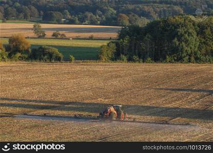 Farm vehicle spraying fertilizer on farmland in North Yorkshire in the United Kingdom.