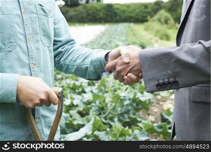 Farmer And Businessman Shaking Hands