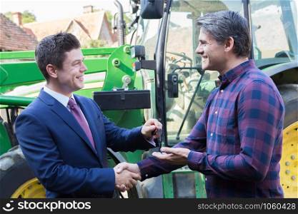 Farmer Collecting Keys To New Tractor