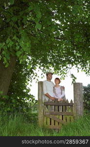 Farmer Couple Standing at Gate