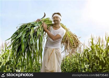 Farmer holding sickle and crops