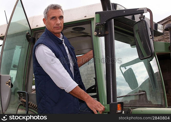 Farmer in the cab of his tractor