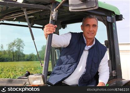 Farmer in the cab of his tractor