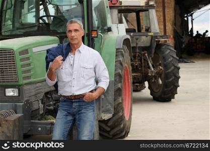 farmer posing near tractors