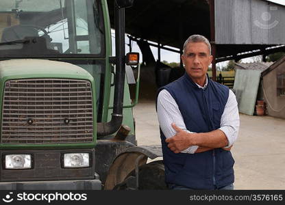 Farmer standing beside a tractor