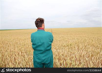 Farmer standing in wheat field in spring season