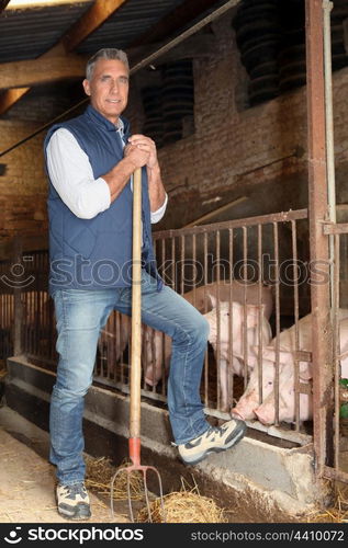 Farmer standing with rake in hand