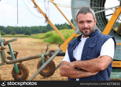Farmer stood by irrigation system