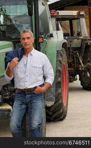 Farmer stood by tractor