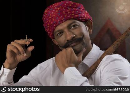 Farmer wearing turban and smoking cigar
