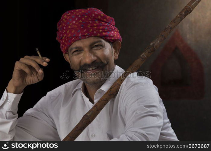 Farmer wearing turban and smoking cigar