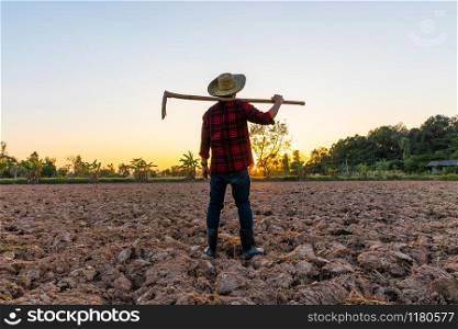 Farmer working on field at sunset outdoor