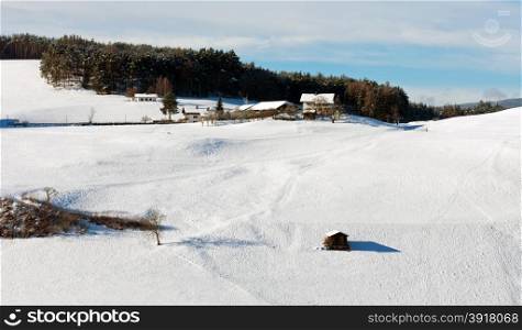 Farmhouses in snow covered farmland, near Castlerotto, Italy