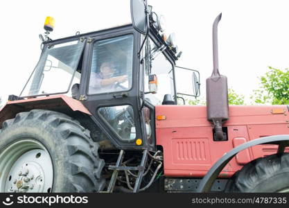 farming, agriculture and people concept - senior man driving tractor at farm