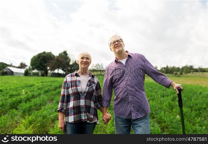 farming, gardening, agriculture and people concept - happy senior couple at summer farm