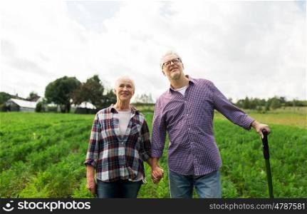 farming, gardening, agriculture and people concept - happy senior couple at summer farm