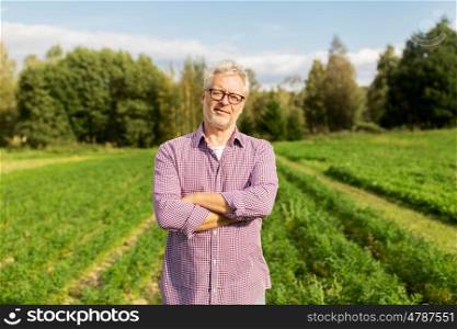 farming, gardening, agriculture and people concept - happy senior man at farm