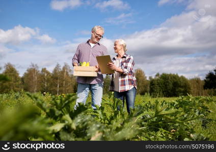 farming, gardening, agriculture, harvest and people concept - happy senior couple with squashes and clipboard at farm. happy senior couple with squashes at farm