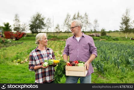 farming, gardening, agriculture, harvesting and people concept - senior couple with box of vegetables at farm