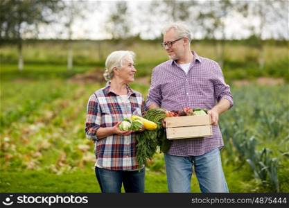 farming, gardening, agriculture, harvesting and people concept - senior couple with box of vegetables at farm