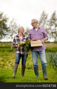 farming, gardening, agriculture, harvesting and people concept - senior couple with box of vegetables at farm. senior couple with box of vegetables on farm