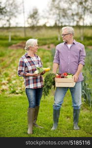 farming, gardening, agriculture, harvesting and people concept - senior couple with box of vegetables at farm. senior couple with box of vegetables on farm