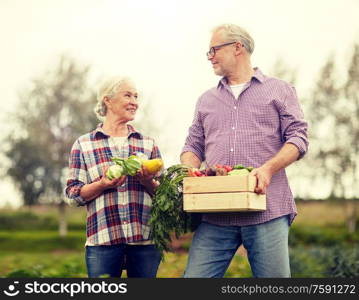 farming, gardening, agriculture, harvesting and people concept - senior couple with box of vegetables at farm. senior couple with box of vegetables on farm