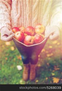 farming, gardening, harvesting and people concept - woman with apples at autumn garden. woman with apples at autumn garden