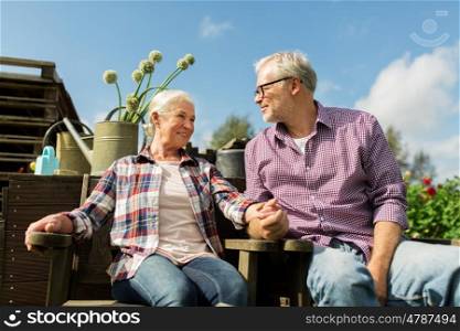 farming, gardening, old age and people concept - happy senior couple at summer farm