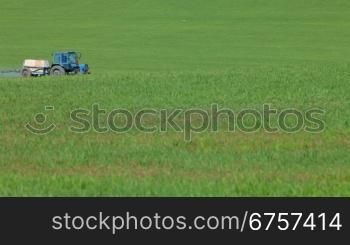 farming tractor spraying a field