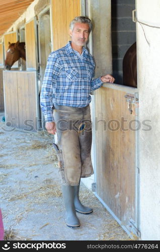 Farrier stood outside of stable
