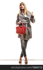 Fashion and advertisement concep t.Full body woman elegant gray belt coat holding red handbag pointing copy space empty blank isolated